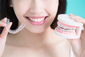 person smiling thanks to Invisalign after braces